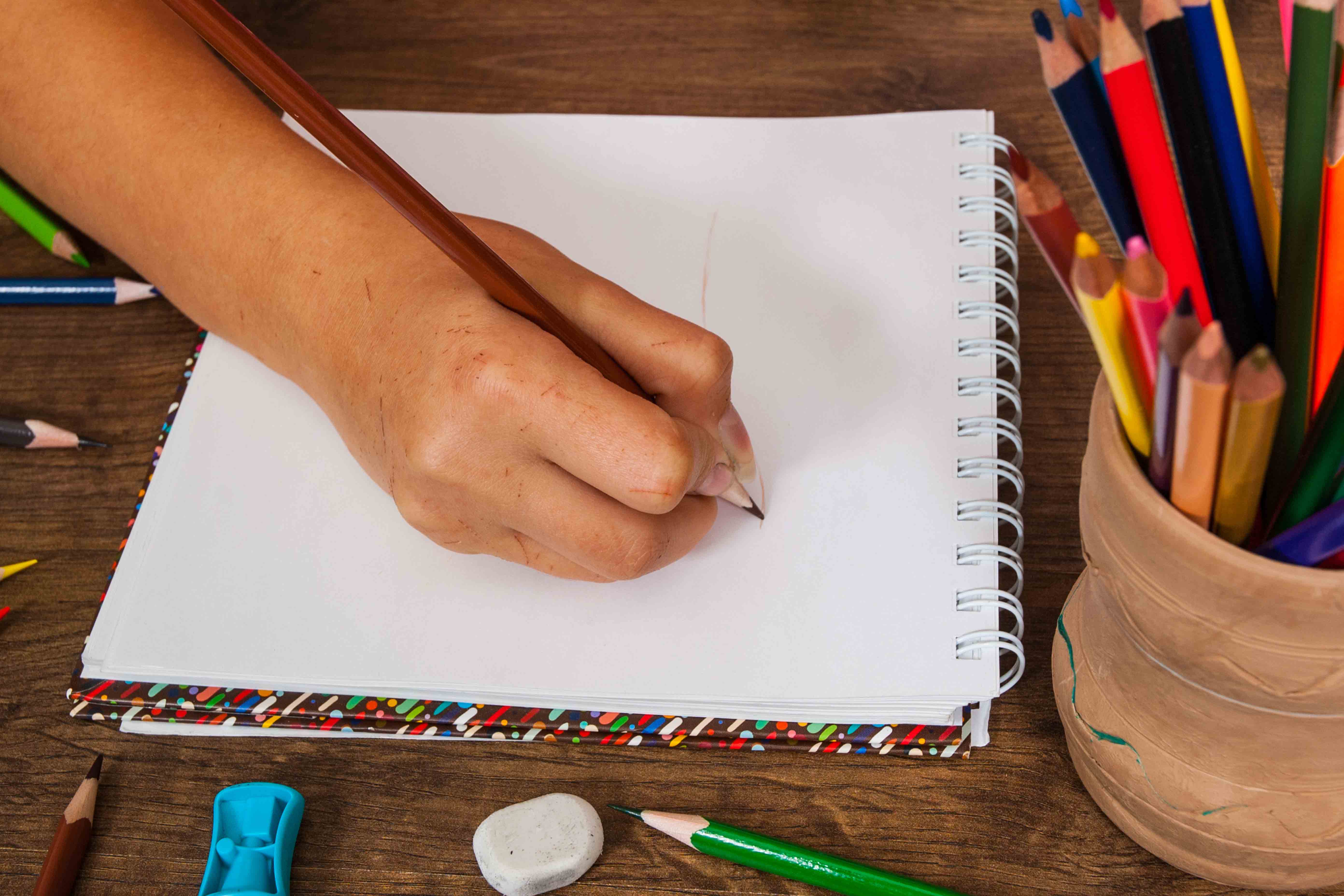 person writing in a notepad